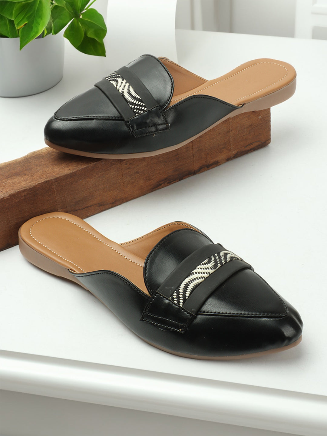 Black mules with a chic white strap, stepping into timeless style